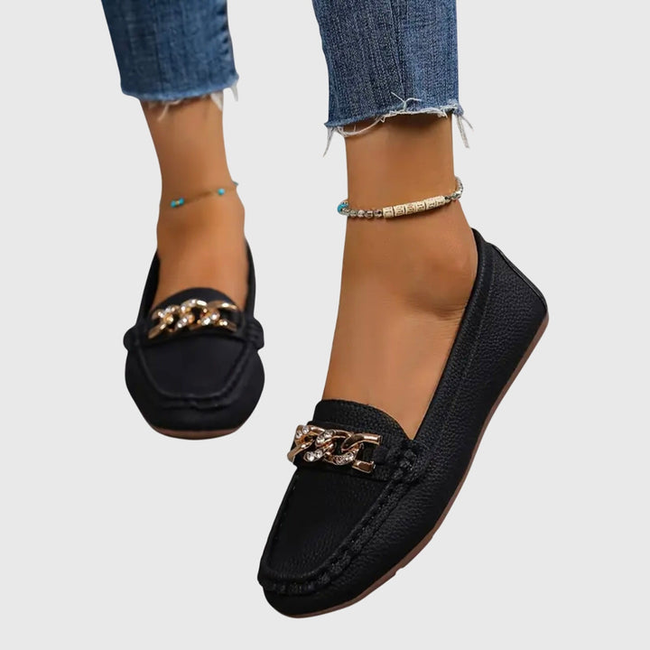 Glamorous women's wedge loafers featuring a decorative gold chain and crystal accent.