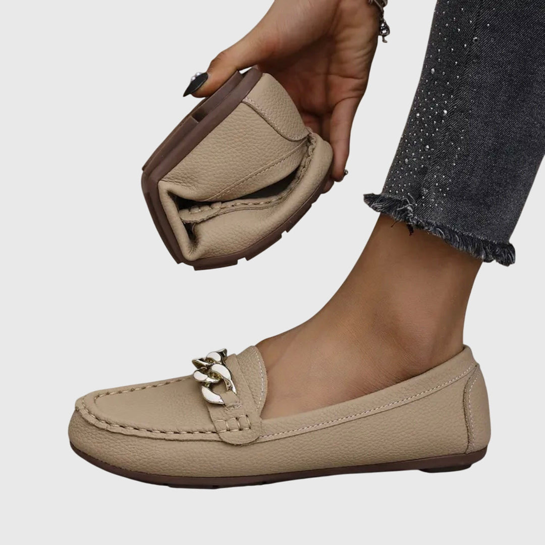 Front view of women's comfortable slip-on wedge loafers with a striking gold chain accent.