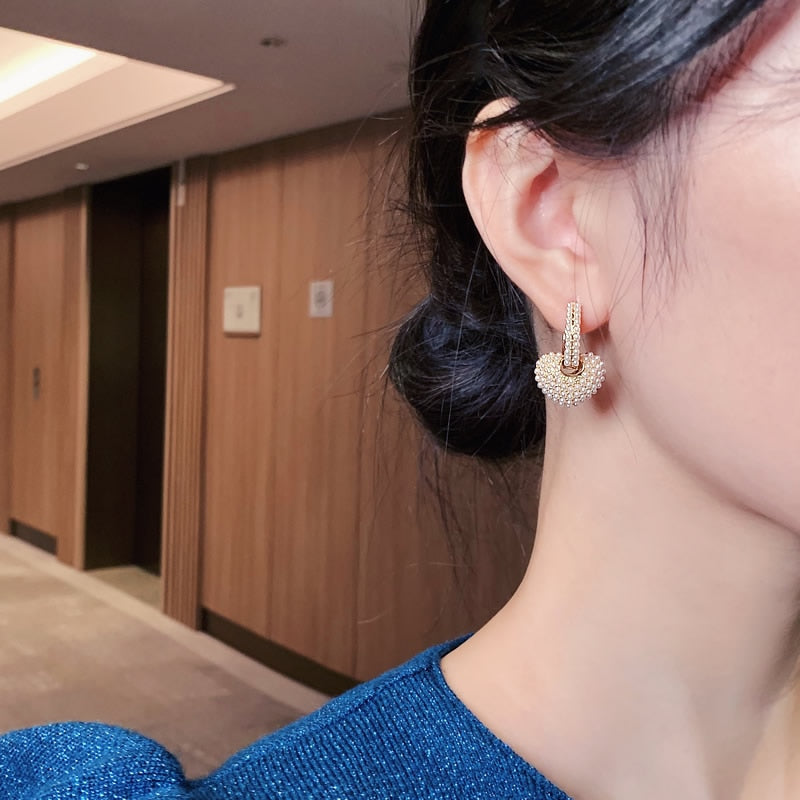 Luxurious gold drop earrings with shimmering pearls. An elegant women's jewelry gift for special occasions.