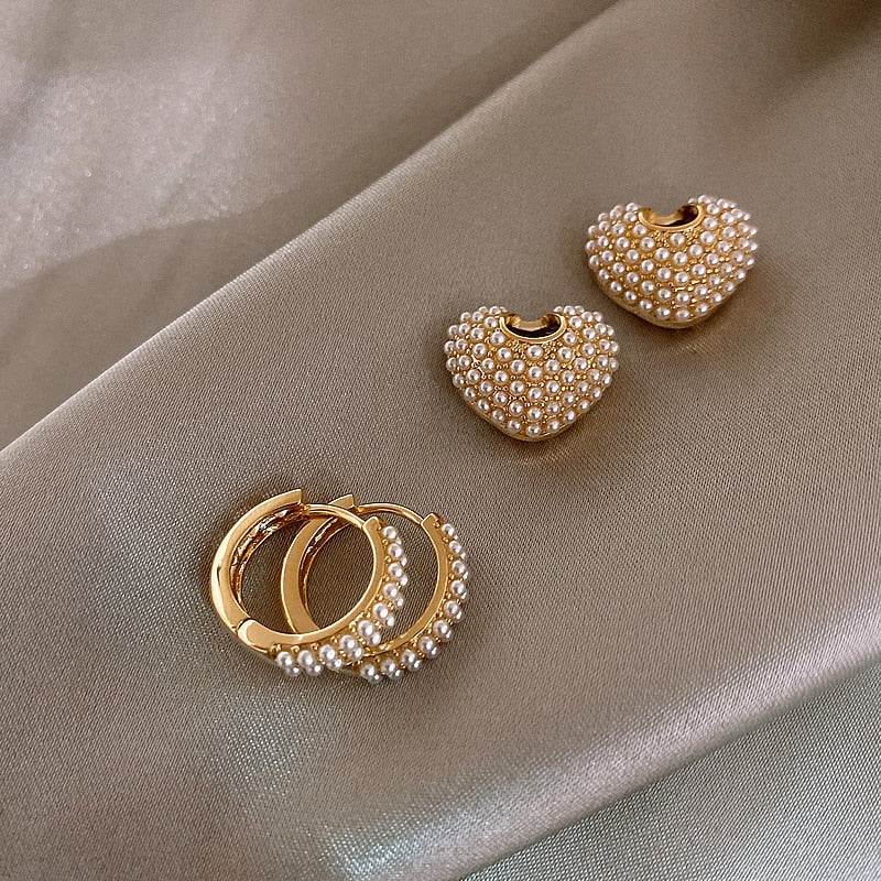 Fashionable women's gold pearl drop earrings. Dainty, elegant, and timeless accessory for her.