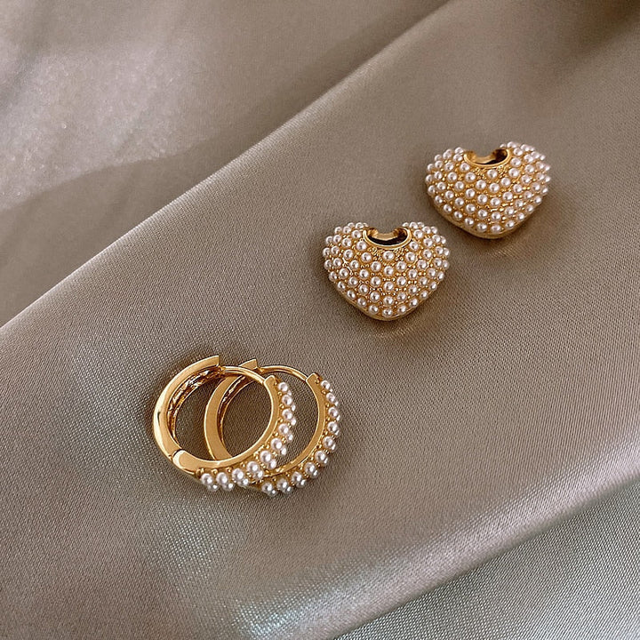 Fashionable women's gold pearl drop earrings. Dainty, elegant, and timeless accessory for her.