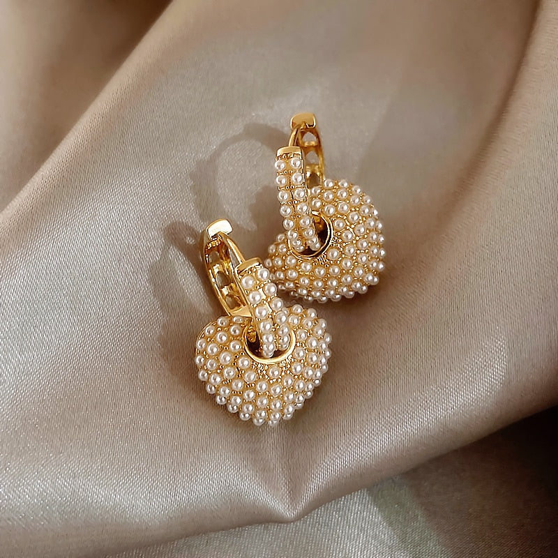 Stylish women's gold pearl drop earrings. Classic design, versatile elegant fashion jewelry.
