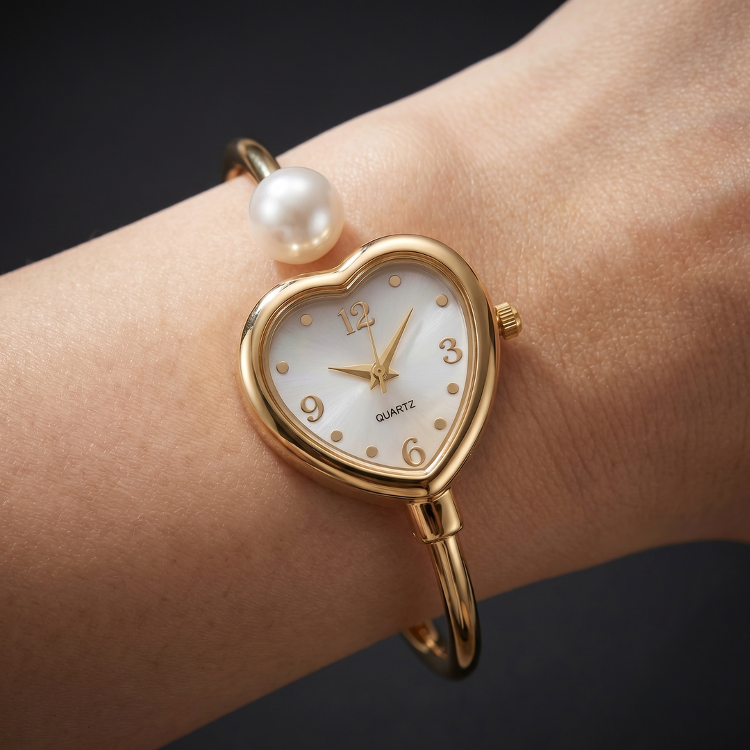 Elegant women's gold fashion watch with delicate pearl accents. A stylish quartz bracelet timepiece.