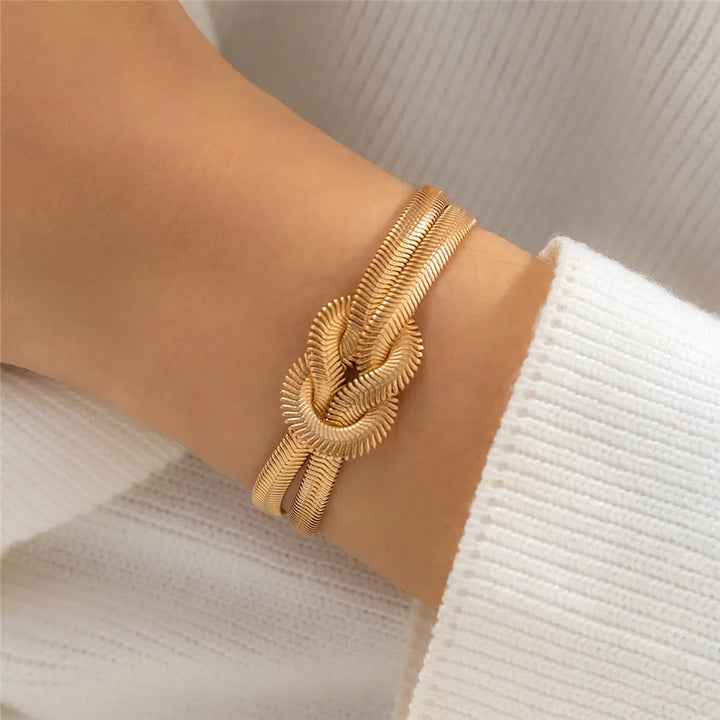 Elegant women's gold knotted snake chain bracelet, a stylish fashion accessory.