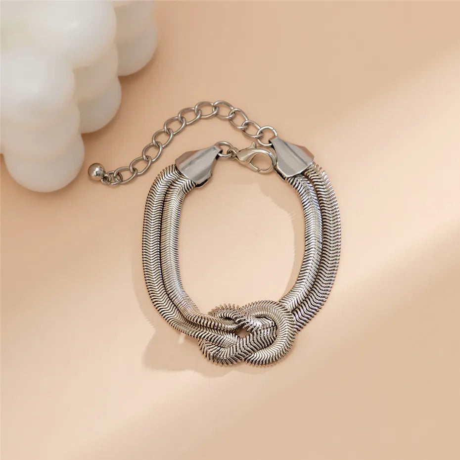 Stylish women's knotted snake chain bracelet, a timeless piece of elegant jewelry.