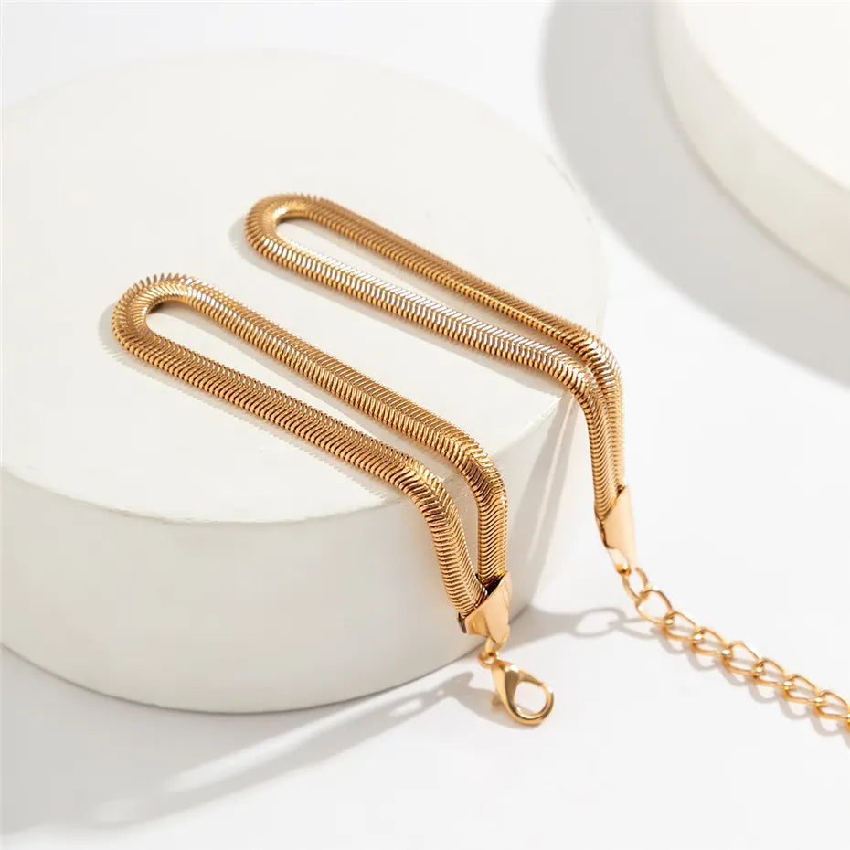 Close-up of an elegant gold knotted snake chain bracelet, a beautiful accessory.