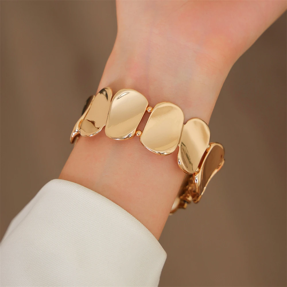 Gold metal smartwatch band for women, elegant jewelry-style watch accessory.