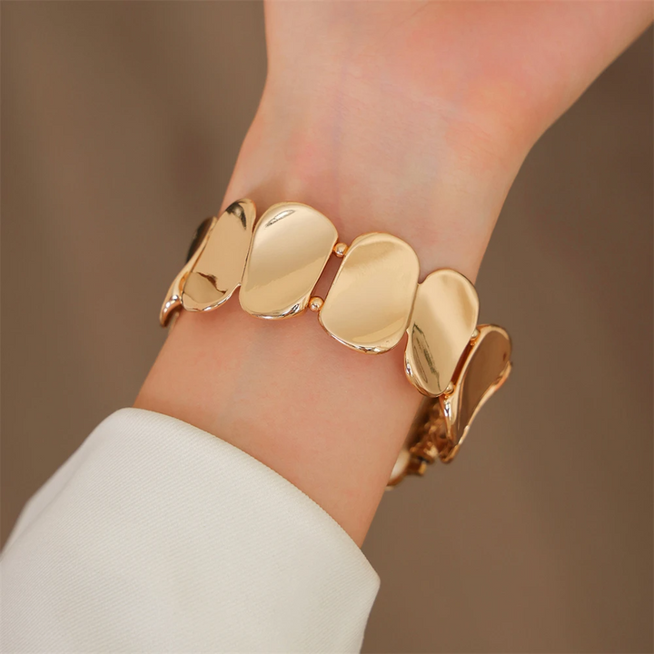 Gold metal smartwatch band for women, elegant jewelry-style watch accessory.