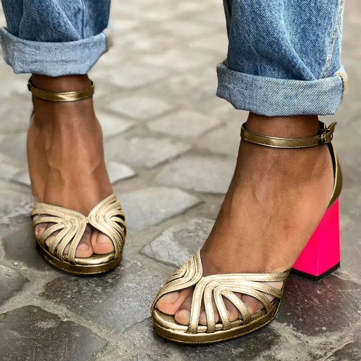Elegant women's gold open-toe block heel sandals with ankle strap, perfect for evening wear or casual chic.