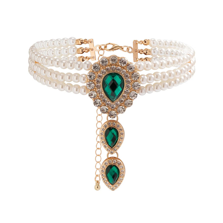 Women's gold jewelry set featuring a pearl & emerald necklace worn elegantly, a luxurious fashion accessory.