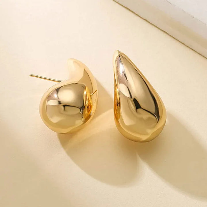 Elegant women's gold plated drop earrings with sparkling crystals, perfect for a glamorous look.
