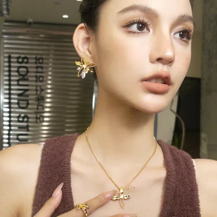 Elegant women's gold plated floral lily petal drop earrings, nature-inspired design for a refined look.