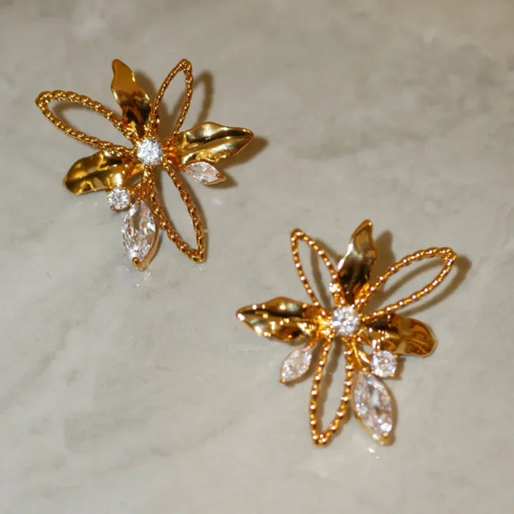 Stunning floral lily petal drop earrings for women, gold plated, bringing a touch of nature's elegance to any outfit.