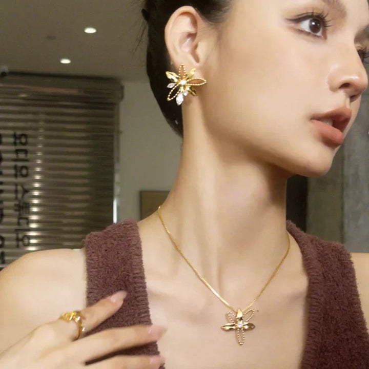 Women's nature-inspired gold plated lily petal drop earrings, elegant floral design, a beautiful addition to your collection.