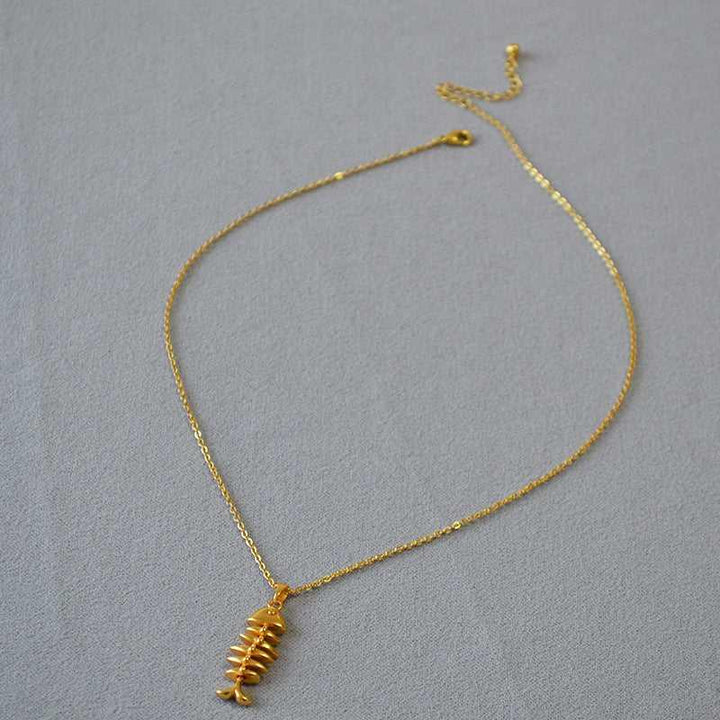Women's shimmering gold plated herringbone chain necklace. Versatile and delicate, ideal for layering or solo wear.