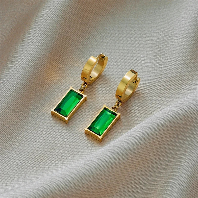 Close-up of a stunning gold plated necklace featuring a vibrant emerald green stone pendant for women.