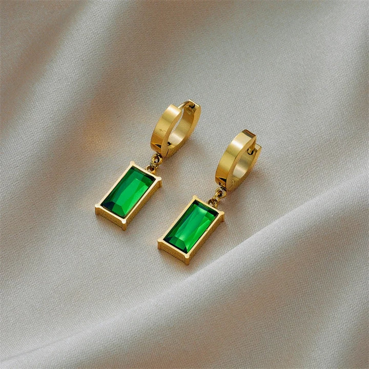 Close-up of a stunning gold plated necklace featuring a vibrant emerald green stone pendant for women.