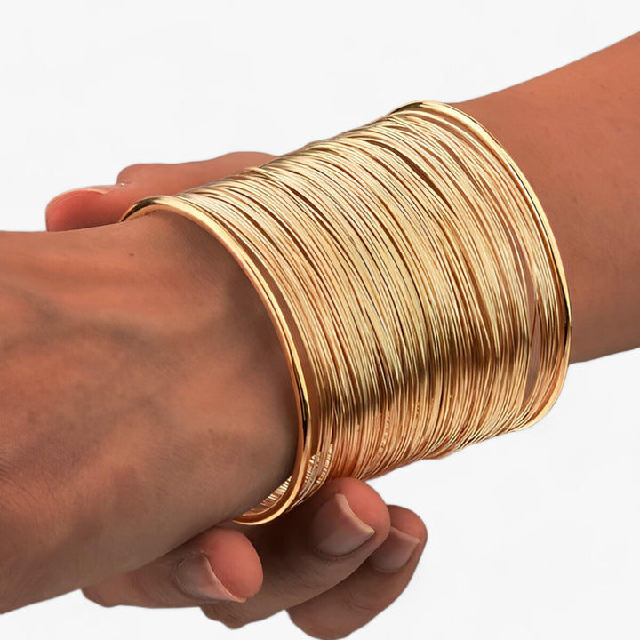 Fashionable gold plated layered wire cuff bracelet for women, adding a touch of elegance.