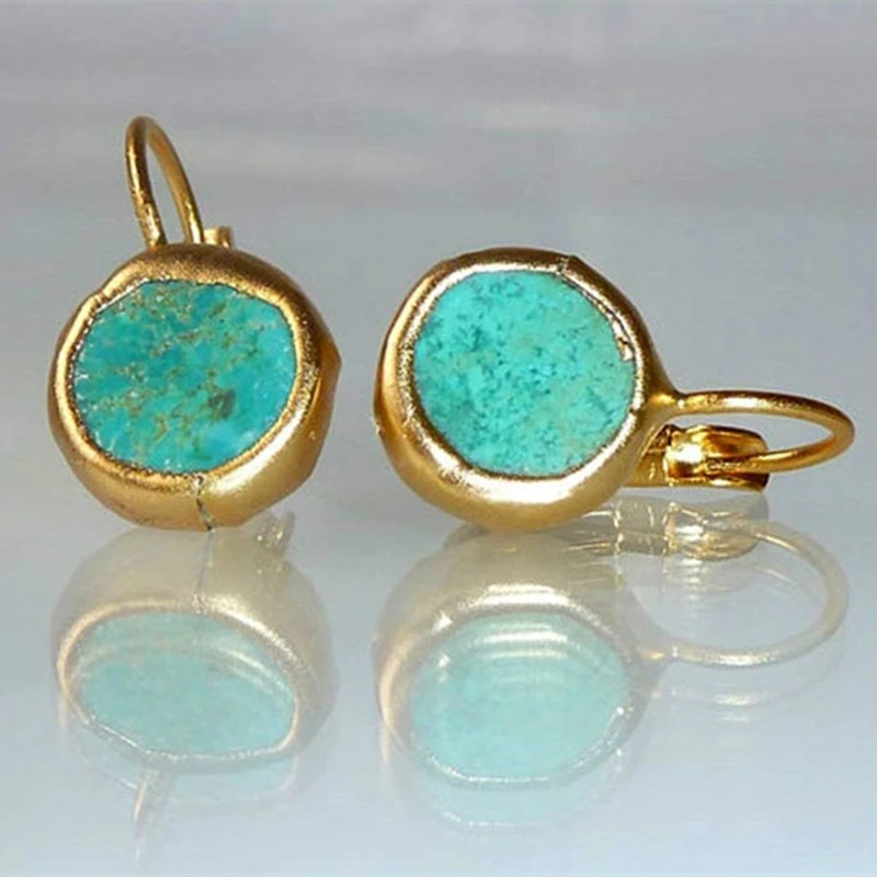 Elegant women's gold plated sterling silver dangle earrings with oval turquoise gemstones.