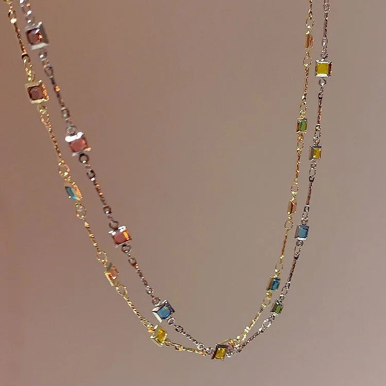 Elegant women's gold & silver necklace with vibrant colorful stones, a versatile and delicate jewelry accessory.