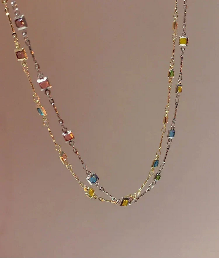 Stylish women's necklace blending gold & silver, adorned with brilliant colorful stones. A chic, delicate accessory.