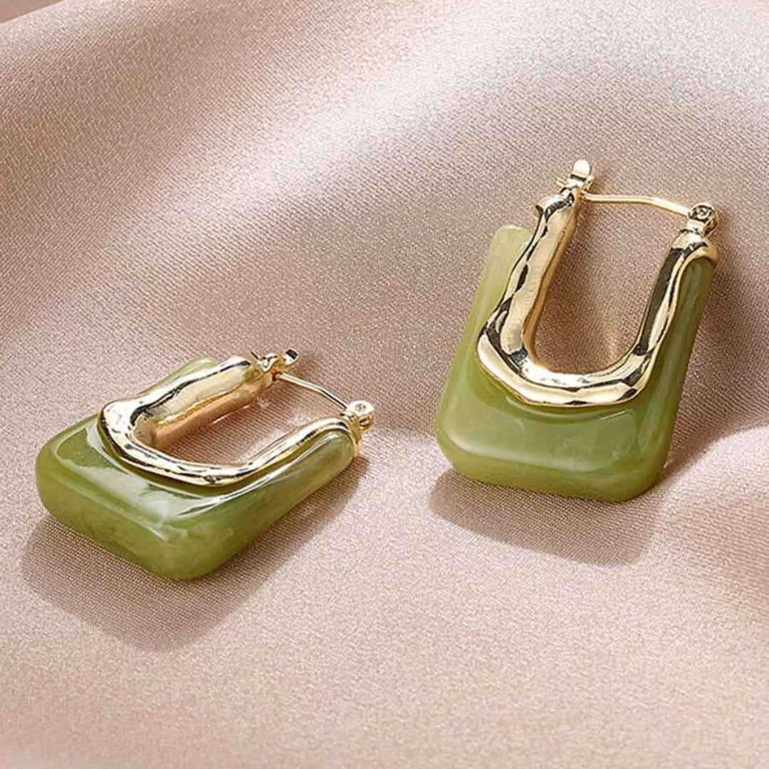 Elegant women's gold vintage earrings featuring detailed green enamel, a stunning jewelry accessory.