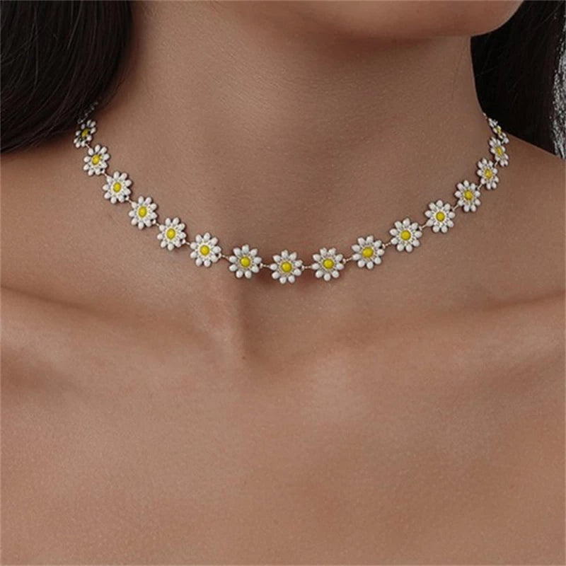 Elegant women's golden daisy chain pendant necklace. Delicate floral jewelry, perfect gift for her.