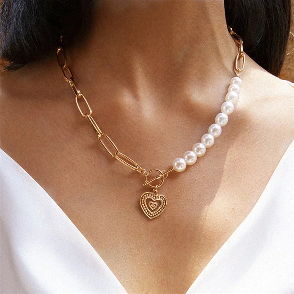 Elegant women's golden heart necklace featuring delicate pearl accents, perfect for a gift.