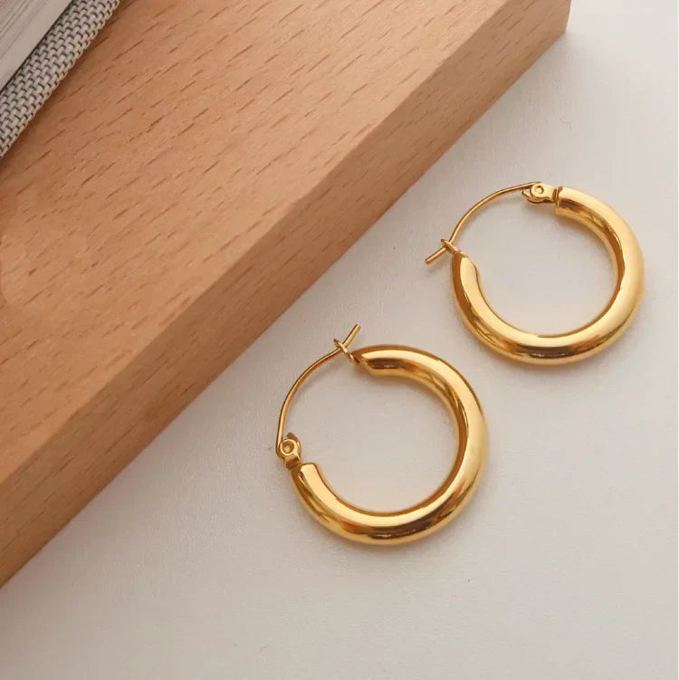 Aurélie golden hoop earrings for women. Elegant, timeless gold jewelry, a sophisticated fashion accessory for her.