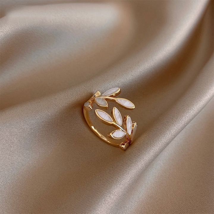 Elegant women's golden leaf ring, nature-inspired design with delicate gold leaves, perfect as a timeless gift.