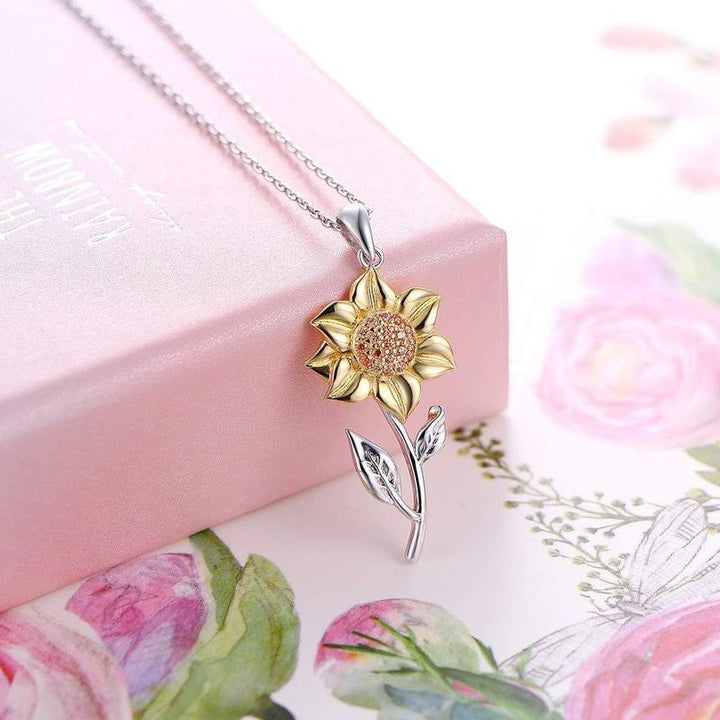 Elegant women's golden sunflower necklace. Intricate floral pendant, adjustable chain. Perfect jewelry gift for her.