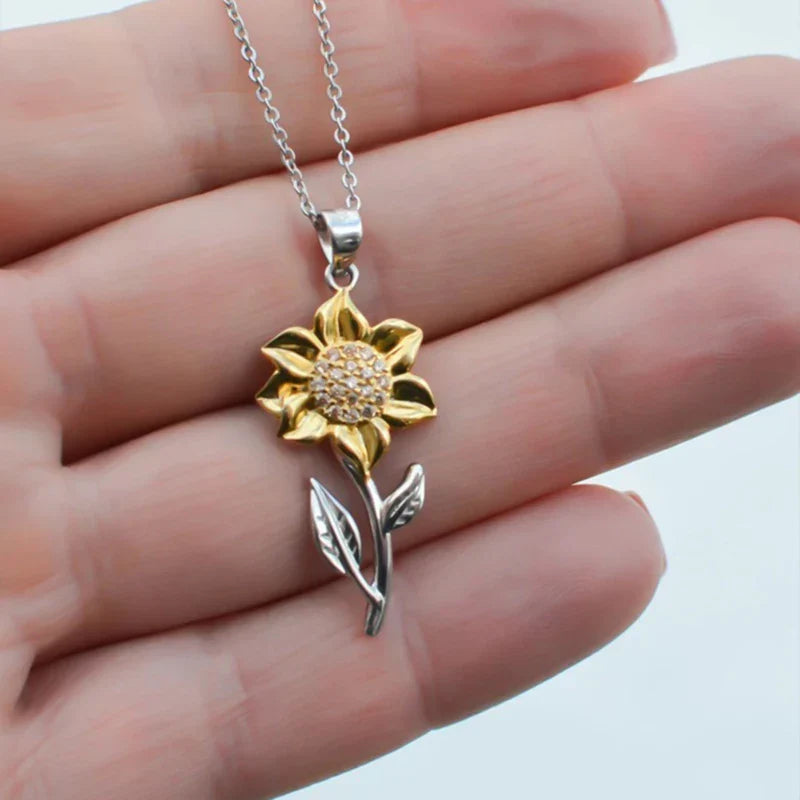 Shiny gold-tone sunflower pendant necklace for women. Delicate floral jewelry, ideal for everyday wear or a special gift.