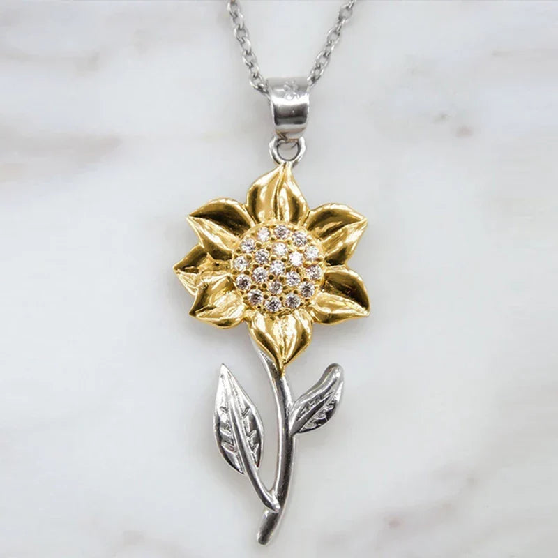 Chic golden sunflower pendant necklace, a beautiful piece of floral jewelry. Enhances womens fashion, adjustable for comfort.