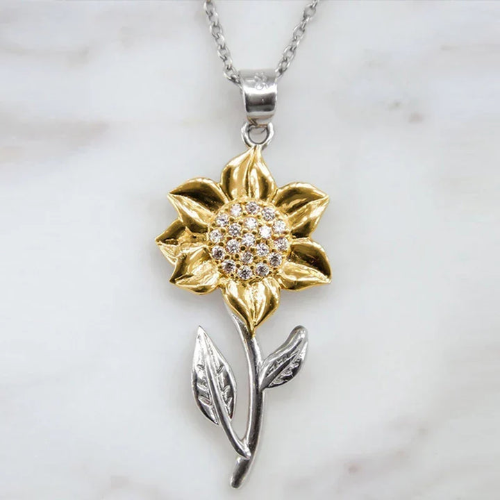 Chic golden sunflower pendant necklace, a beautiful piece of floral jewelry. Enhances womens fashion, adjustable for comfort.