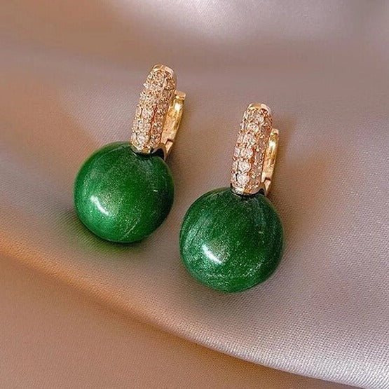 Elegant women's green and gold pearl drop earrings. Stylish fashion accessory, perfect gift for her.