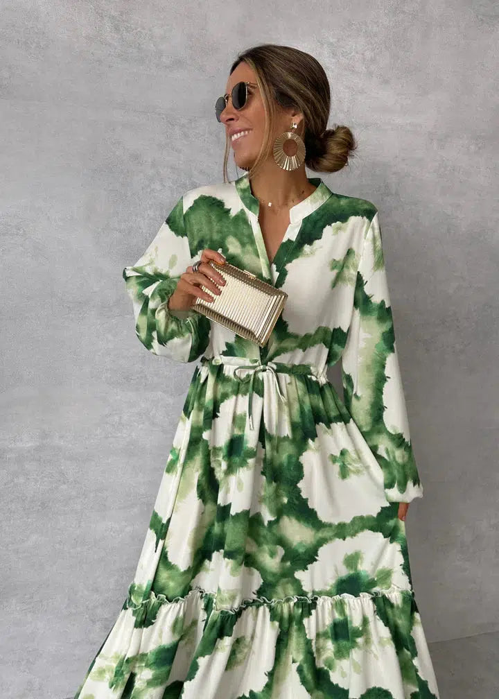 Stylish women's green maxi dress with long sleeves. Elegant design & pointed neckline, ideal for evening gowns.