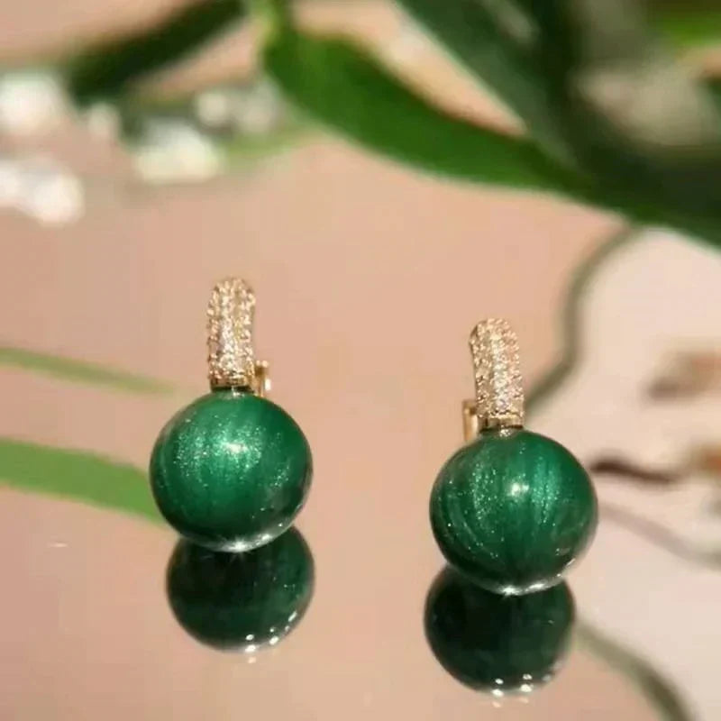 Stylish green pearl drop earrings, a luxurious and elegant gift for her, featuring gold plating.