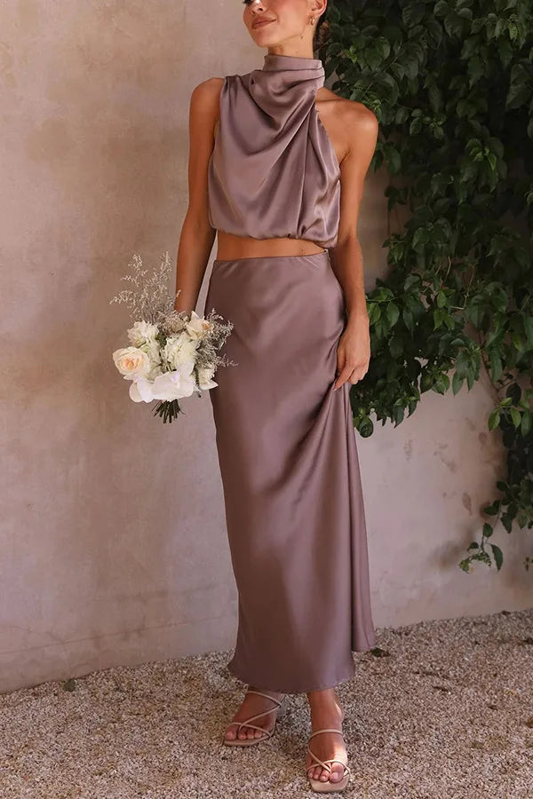 Glamorous flowy maxi skirt and draped halter crop top women's 2-piece set. Perfect for elegant evenings.