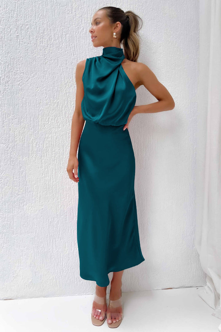 Wedding guest halter dress. Elegant floor-length, open-back gown for women, ideal for special events.
