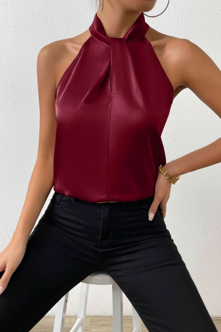 Stylish women's halter blouse with a chic knot front. Sleeveless design for warm weather fashion.