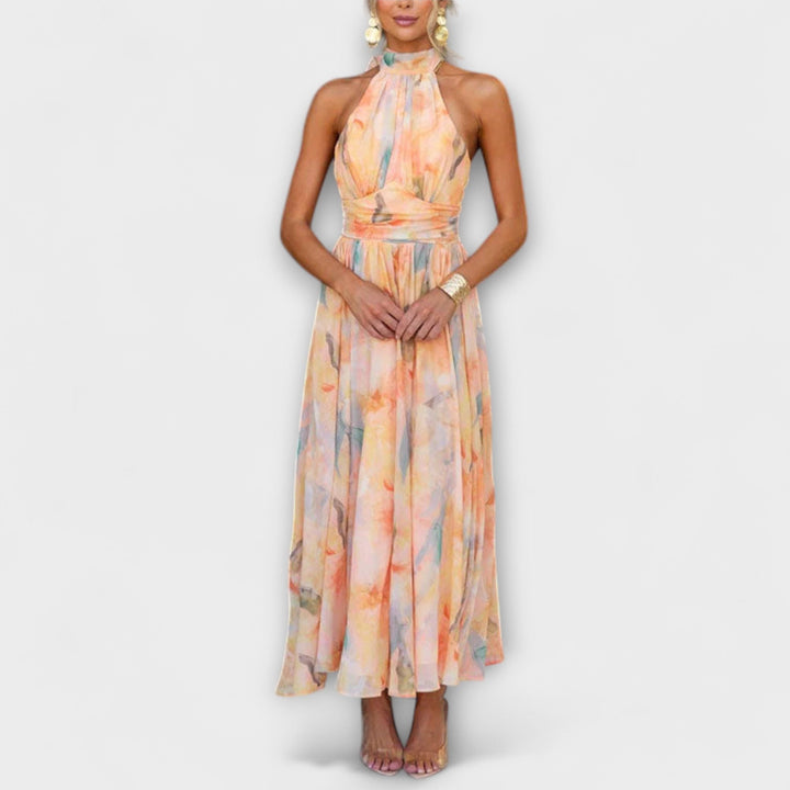 Elegant women's halter maxi dress with vibrant watercolor print, perfect for summer events and special occasions.