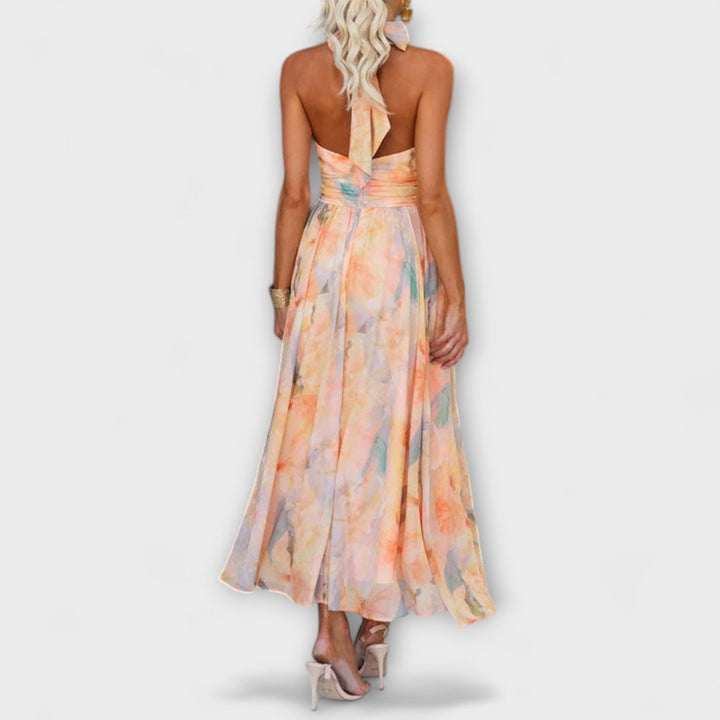 Flowy open-back halter maxi dress, ideal for beach weddings, evening wear, or elegant summer occasions.