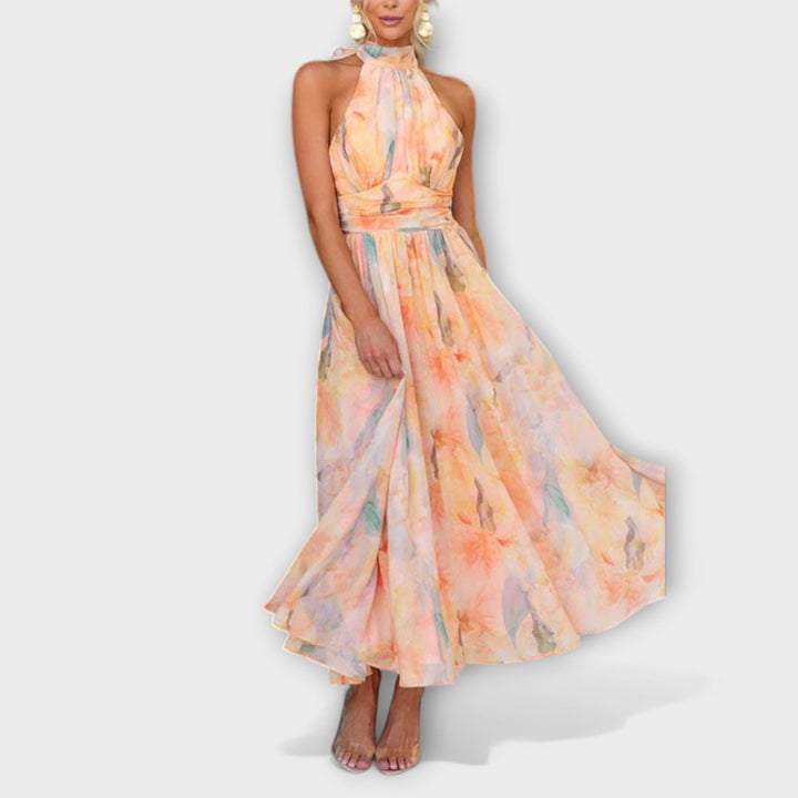 Stylish women's summer halter maxi dress with an elegant silhouette and eye-catching watercolor pattern.