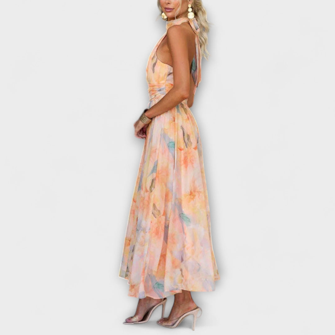 Women's occasion wear halter maxi dress featuring a chic open back & unique watercolor print for summer elegance.