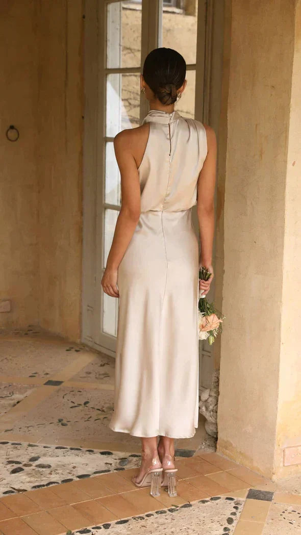 Flattering flowy midi dress with a halter neckline, ideal for summer parties and cocktails.