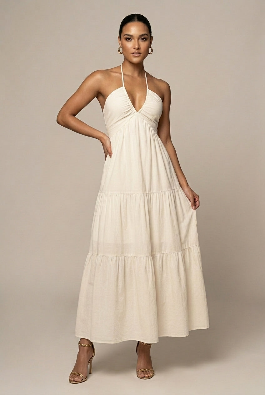 Elegant women's halter neck tiered maxi dress with open back, perfect for summer parties.