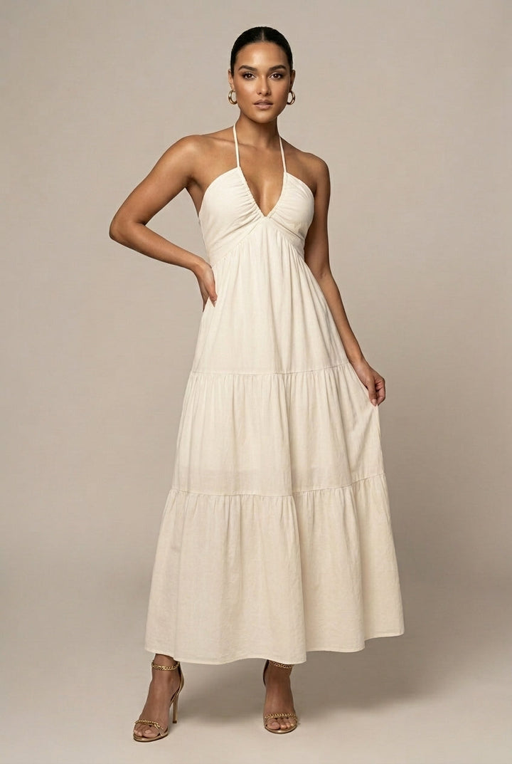 Elegant women's halter neck tiered maxi dress with open back, perfect for summer parties.
