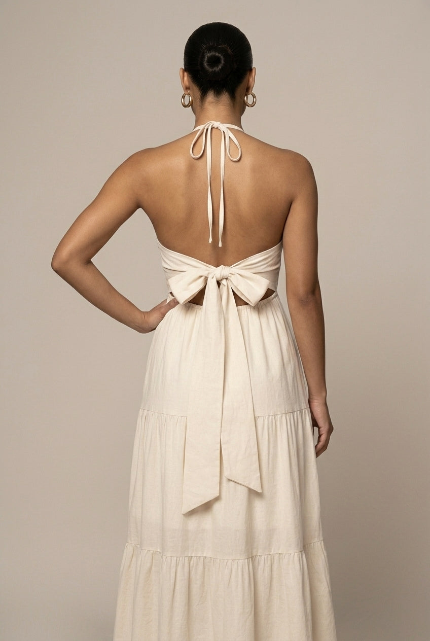 Stylish women's tiered maxi dress, halter neck, ruffle skirt, and chic open back detail for formal events.