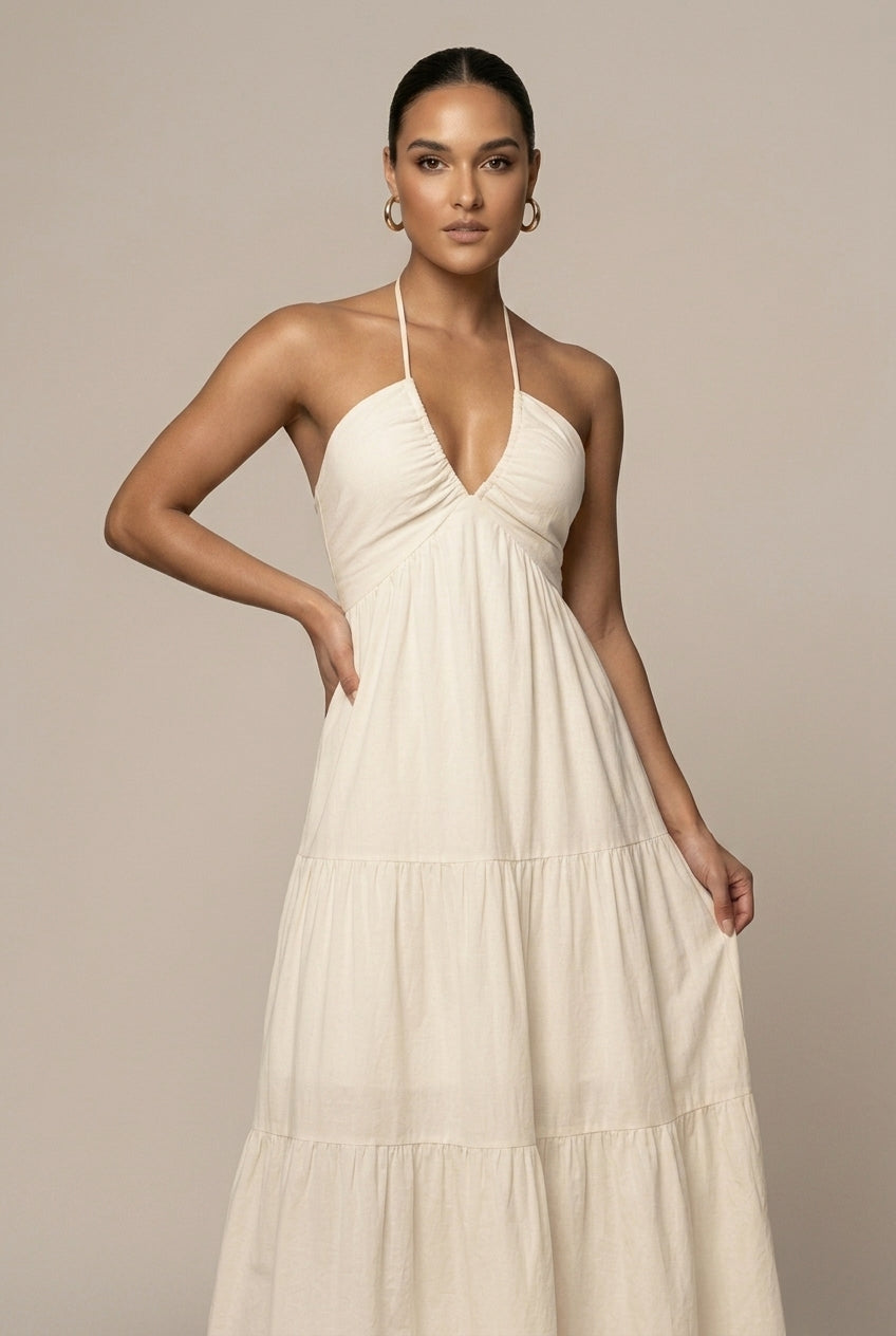 Flowy women's halter neck tiered maxi dress, comfortable & stylish for warm weather, featuring an open back.