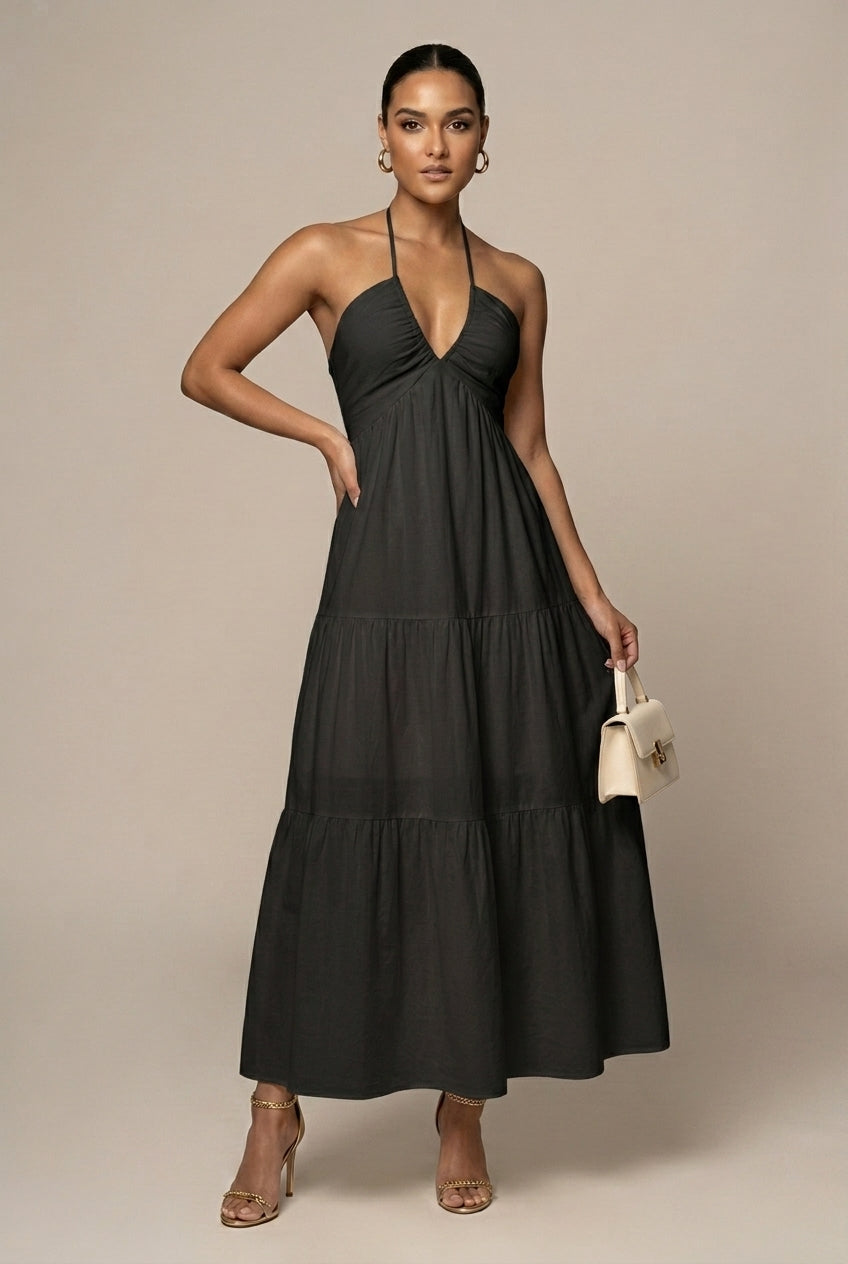 Sophisticated women's maxi dress, halter neck, tiered skirt, open back, ideal for formal summer occasions.